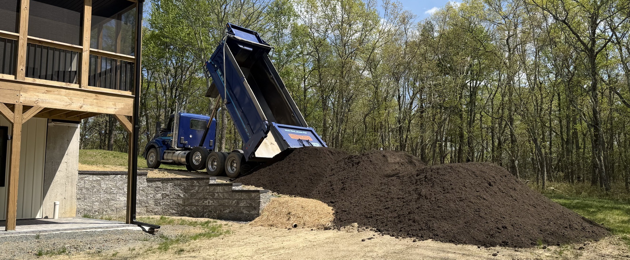Topsoil being delivered near a home