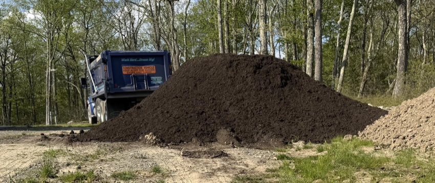 Fresh topsoil pile delivered by Hauling Harts